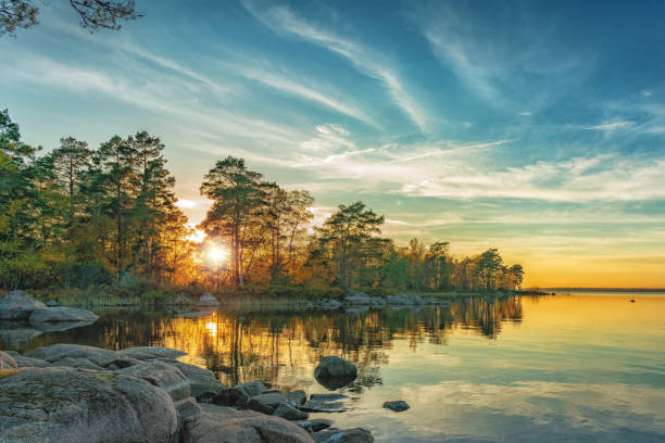 Autumn landscape on the lake at sunset time.